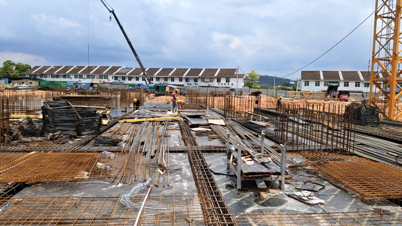 Construction site with heavy machinery and steel beams.